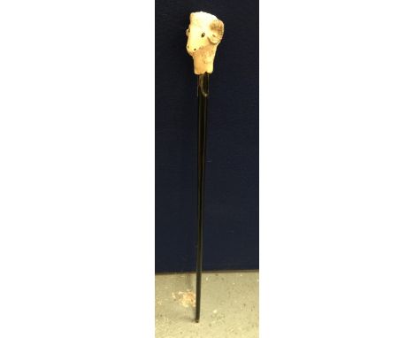 A VINTAGE EBONISED WALKING STICK WITH RAMS HEAD DESIGN TOP, SIGNED WH 