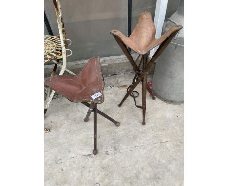 TWO VINTAGE LEATHER FOLDING TRIPOD STOOLS 
