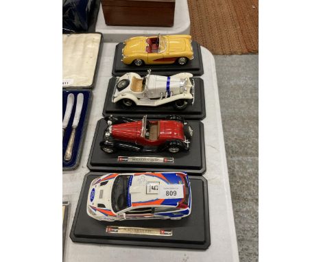 FOUR LARGE DIE-CAST CARS ON PLINTHS, A FORD, BUGATTI, MERCEDES AND A CHEVROLET 