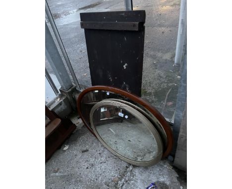 AN OVAL GILT FRAMED WALL MIRROR AND OVAL MAHOGANY AND INLAID MIRROR 