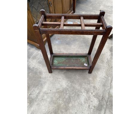 A MID 20TH CENTURY OAK SIX DIVISION STICK STAND 