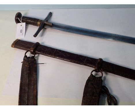 A very fine Sudanese Sword, Kaskara in tooled leather scabbard 