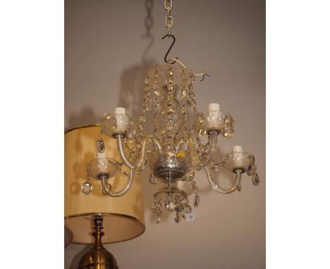 A five-light cut glass chandelier, a pair of gilt wall lights and one other light 