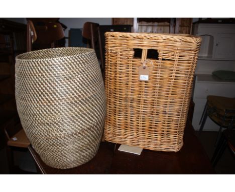 A wicker linen basket, 22" wide x 18" deep x 23" high, a circular, lidded, woven cane basket, 14" dia x 21" high and a lamp s