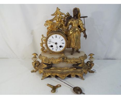 An antique French mantel clock with pendulum and key 