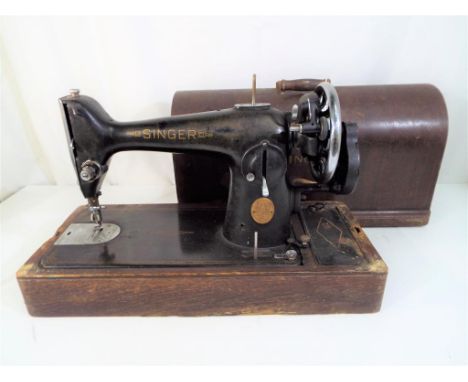 A decorative vintage Singer sewing machine in wooden case, serial # EE105212