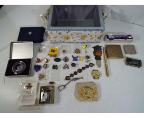 A sewing box, containing a quantity of mixed collectables to include pin badges, powder compacts, fountain pen, cigarette lig