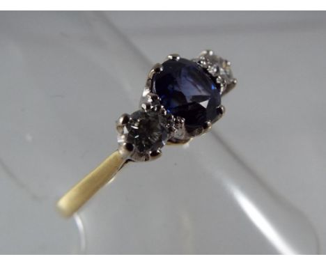 A lady's 18 carat yellow gold three stone sapphire and diamond ring, the centre stone of old cut sapphire measuring .75 to 1 