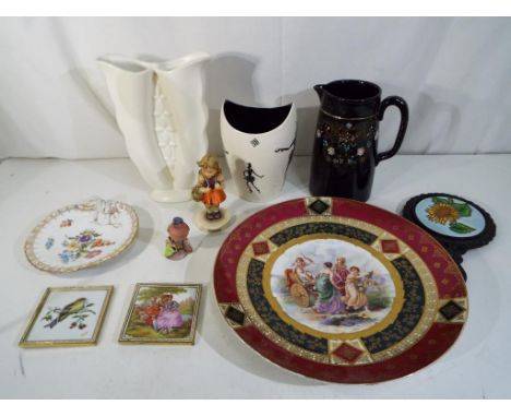 A mixed lot to include a Royal Vienna style charger, Dresden ceramic dish, Wade Zamba pattern vase, Falcon Ware vase, Hummel 