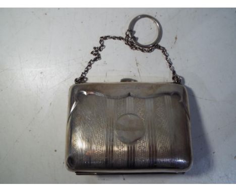 A silver hallmarked purse with engine turned decoration, assay mark rubbed but probably Birmingham 1916, approximately 109 gr