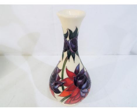 A Moorcroft vase in the Ruby Red pattern, approximate height 17 cm (h). Estimate £85 - £100