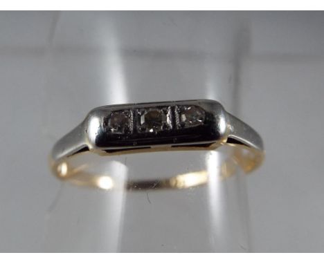 A lady's 18 carat yellow gold and platinum three stone diamond ring set with eight-cut diamonds, approx 1.95 gm (all in), siz