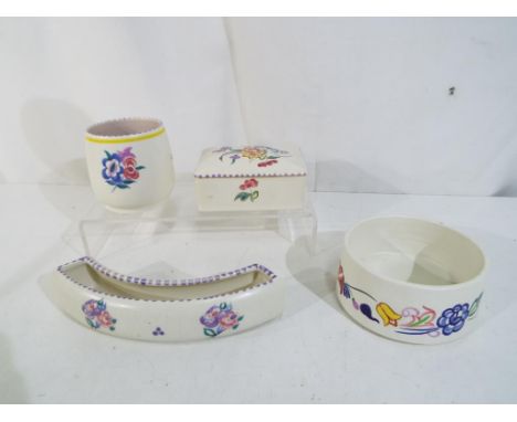 Poole Pottery - four pieces of Poole pottery with florakl decoration to include a lidded trinket box, small bowl, small vase 