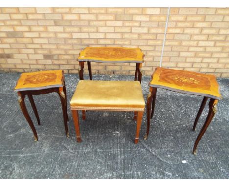 A nest of three tables with inlaid decoration and brass mounts, largest approximately 57 cm x 63 cm x 45 cm with an upholster