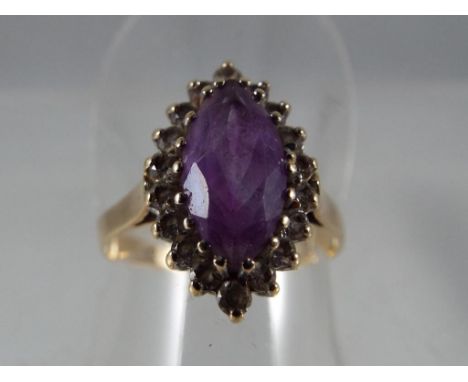 A lady's 9 carat yellow gold cz and Amethyst marquise shaped cluster ring, approx 2.75 gm (all in) size Q - Est £30 - £50