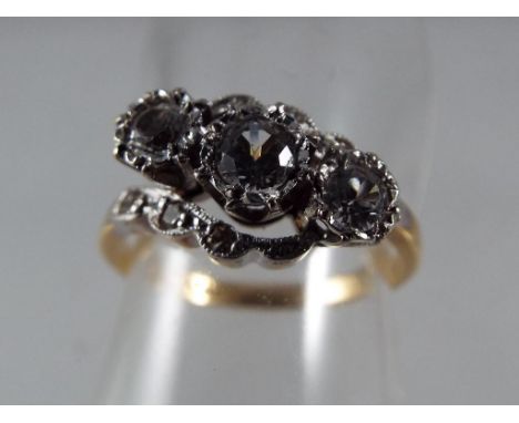 A lady's 18 carat yellow gold and platinum three stone diamond crossover ring, approx ½ carat total diamonds, 3.32 gm (all in