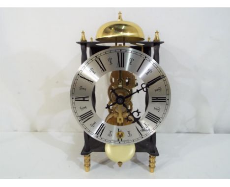 A Hermal skeleton type mantel clock with a key and pendulum, Est £30 - £50.