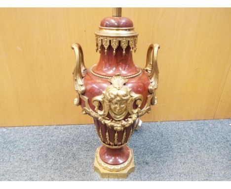 A decorative red marble based table lamp with applied brass detailing, with shade, approximately 74 cm (h) including shade.