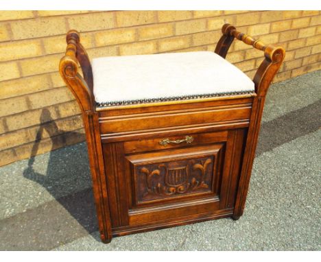 A professionally restored Edwardian carved oak piano stool, the hinged seat re-upholstered in beige - Est £40 - £60