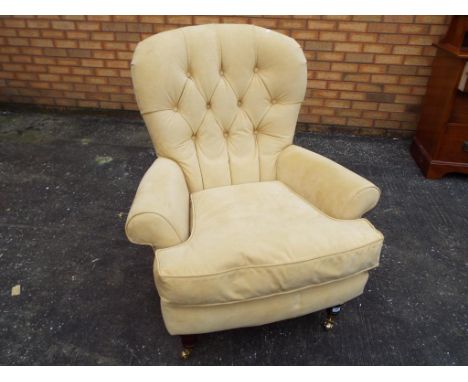 A good quality button back chair, the front two legs having castors.