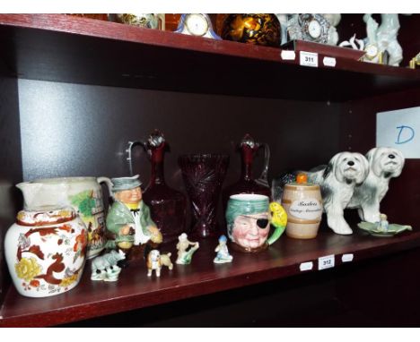 A good mixed lot of glassware and ceramics, to include two cranberry glass decanters, a cranberry cut to clear vase, a Masons