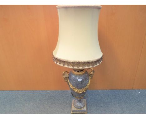 A good quality grey marble based table lamp with applied brass ram's mask handles and foliate decoration, approximately 80 cm