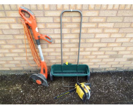 A Flymo contour 600 heavy duty strimmer, a McCullach petrol chainsaw, also included in the lot is Evergreen Pull Along seed s