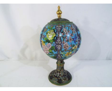 A Chinese cloisonne lidded jar of globular form raised on stem support, decorated with flowers, birds and insects, ruyi borde