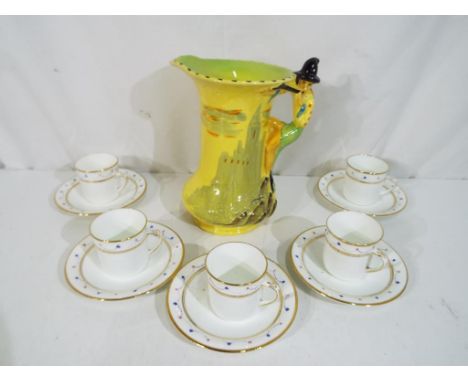 A set of five cup and saucers by Diamond Care China displaying kite mark to the base #7387 and a Burley Ware water jug, appro