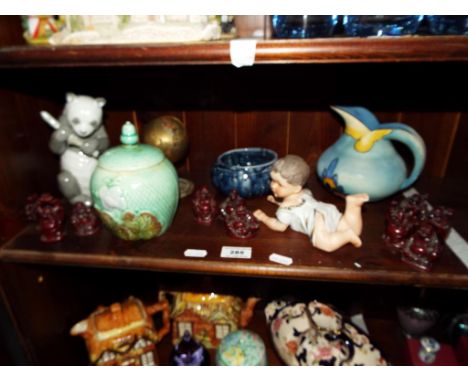 A good mixed lot to include a Piano Baby, a Nao figurine of a panda bear, ten Asian Buddhas, a Samara water jug, a brass ciga