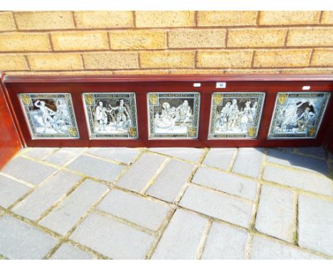 A mahogany panel set with five Minton ceramic tiles marked Moyr Smith each tile approx 21cm x 21cm depictions including Guy M