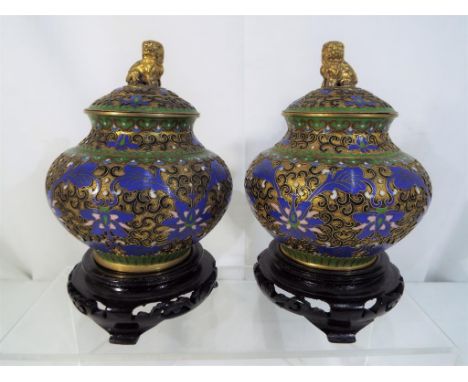 A pair of Chinese cloisonne enamelled lidded pots scrolling floral and foliate decoration, ruyi border to the neck and should