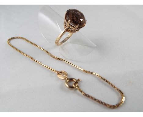 A hallmarked 9ct gold ring set with smoky Topaz size J, approx weight 3.05grams also included in the lot is a 9ct gold bracel