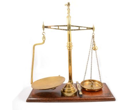 Set of Millward patent brass balance scales, on mahogany plinth base, with weights.