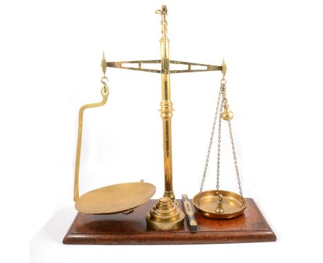 Set of Millward patent brass balance scales, on mahogany plinth base, with weights.