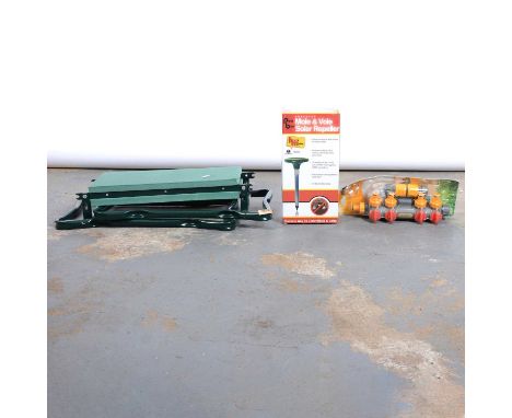 A box containing hose pipe, garden gloves, etc.
