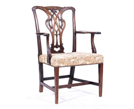 A Chippendale style mahogany elbow chair, possibly Irish, late 18th Century, scrolled and foliate cresting, pierced vase spla