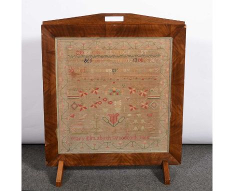 Victorian needlework sampler, Mary Elizabeth Woodcock, 1866, floral motifs within a meandering border, adapted as a fire scre