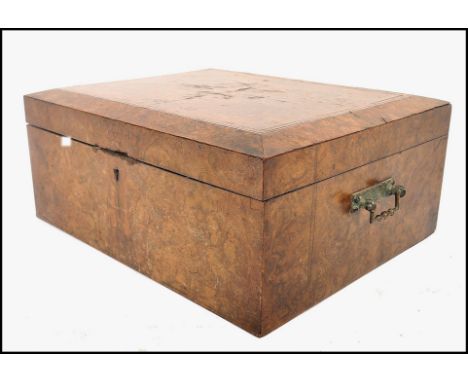 A 19th century walnut veneered work box of square form having quarter panel veneered lid with canted edges and brass swing ha