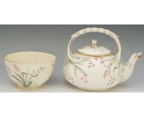 A Belleek porcelain teapot with wrapped leaf handle, the cover with tied leafage, the body enamelled with floral sprays in pi