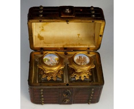 A 19th Century novelty leather box in the form of a domed travelling trunk, the body studded and worked to resemble wooden pa