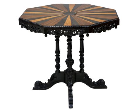 An Anglo- Indian octagonal centre table the top inlaid in coloured woods centred on an ebony roundel, reel carved border and 