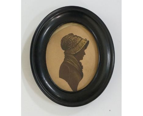 A pair of early 19th Century oval silhouette head and shoulder portrait miniatures, brown and black heightened with gold, on 