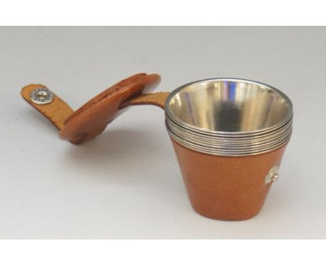 A set of ten steel hunting stirrup cups, the numbers 1 to 10 stamped to their bases, tan leather holder with button clasp, 5.