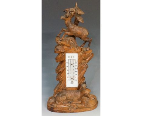 Black Forest - a thermometer, the glass register inscribed RFC with two mountain goats, oval base, 35cm high, early 20th Cent