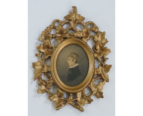 A 19th Century oval  portrait miniature of a young boy in profile, head and shoulders, watercolour, 7cm x 5.25cm contained wi
