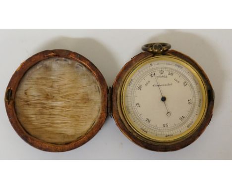 A 19th Century lacquered brass cased pocket barometer, the silver circular dial inscribed Rain/Change/Fair, Compensated, cont