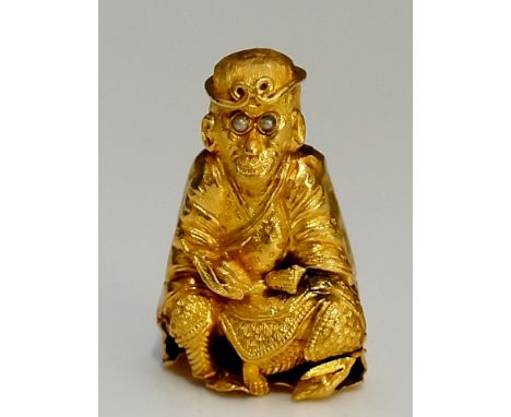 A 22ct yellow gold Chinese or Thai monkey god amulet with seed pearl eyes his robes finely detailed, possibly Sun Wukong or R