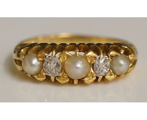A ladies yellow gold diamond and pearl ring, the pierced shoulder set with central split seed pearl flanked by pair of small 