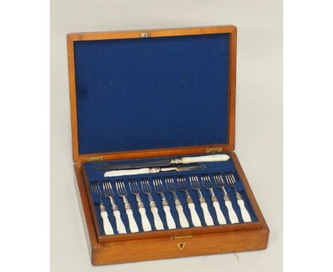 A cased set of fruits knives and forks with servers, comprising eighteen fruit forks, sixteen fruit knives and a pair of serv